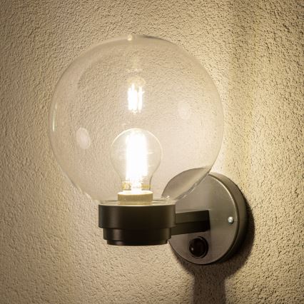 BRILAGI - Välisseinavalgusti liikumisanduriga HARBOR 1xE27/40W/230V IP33 antratsiit/läbipaistev