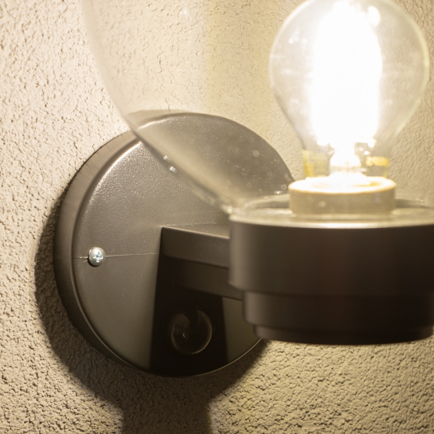 BRILAGI - Seinale paigaldatav välisvalgusti liikumisanduriga HARBOR 1xE27/40W/230V IP33 must/selge