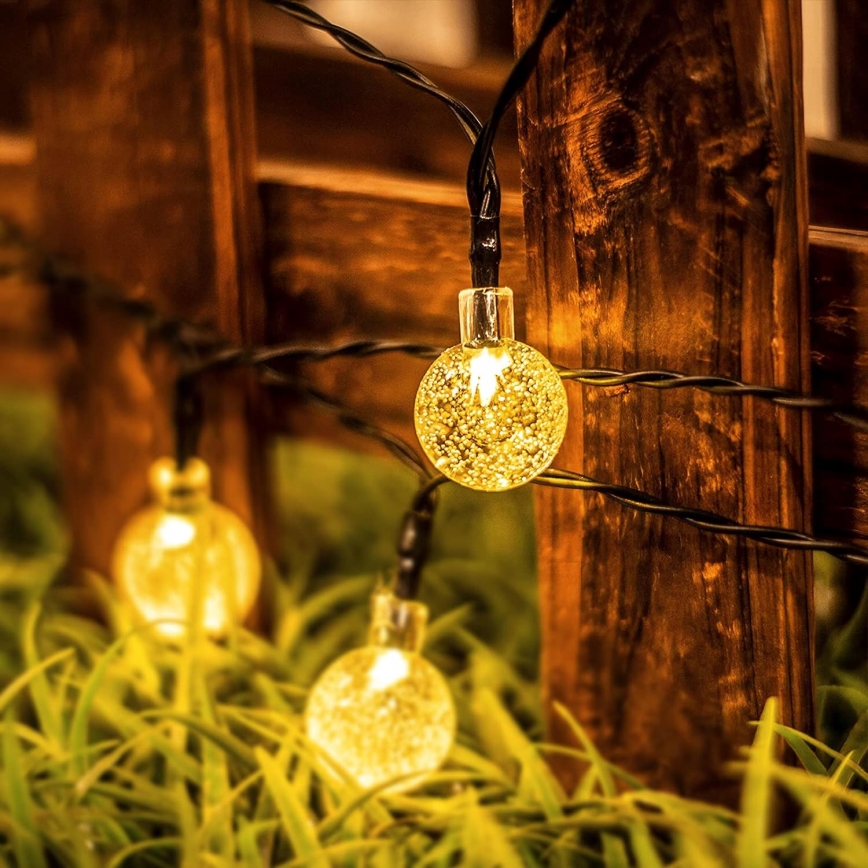 LED päikesepaneeliga dekoratiivne valgusketi 50×LED/8 režiimi 500 mAh 9,5 m IP67 soe valge