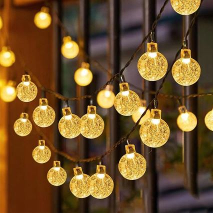 LED päikesepaneeliga dekoratiivne valgusketi 50×LED/8 režiimi 500 mAh 9,5 m IP67 soe valge